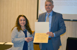 2019 DSCC Award of Merit Winner Yesenia Bustamante shakes hands with Executive Director Thomas Jerkovitz