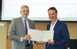 Executive Director Thomas F. Jerkovtiz presents Ned Kostur with his Award of Merit nomination certificate