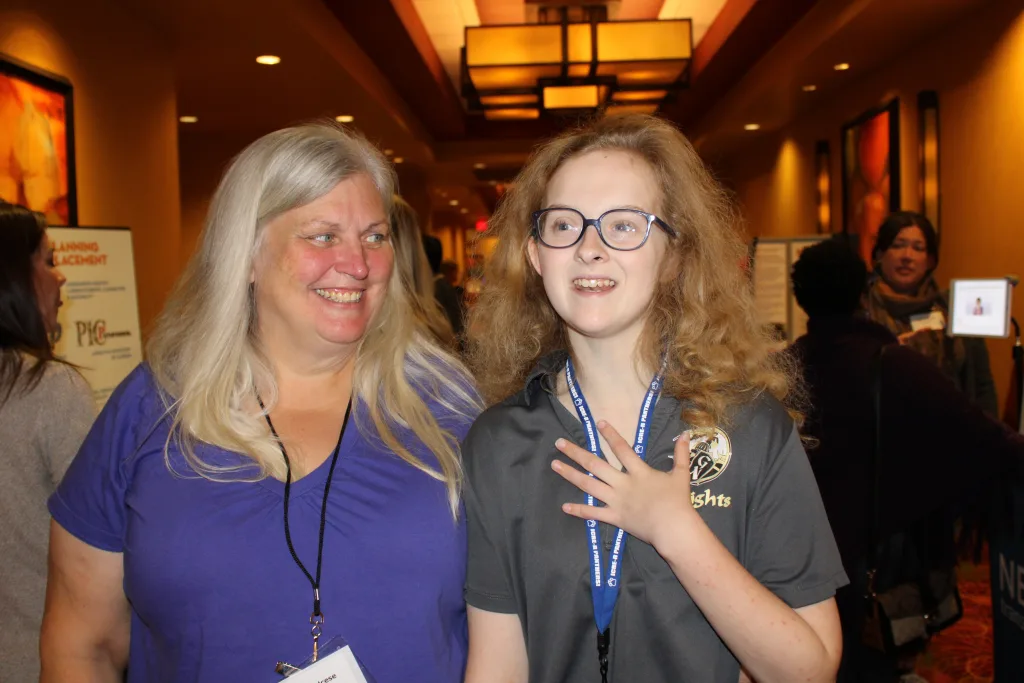 Cheryl Calcese smiles at her granddaughter, Vera Lynn Lindquist, in the exhibitor hall at the 2023 Illinois Statewide Transition Conference.