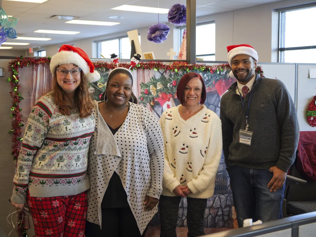 Meeka Hudson wears a festive snowman headband and poses with three of her teammates during the 2023 Mokena Winter Wonderland event for families.
